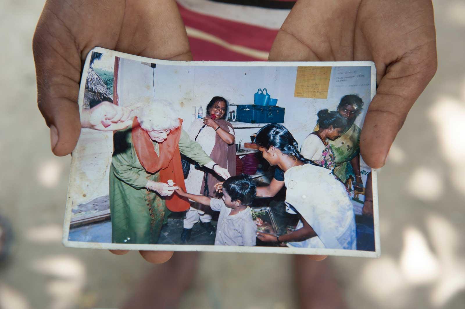 Hands holding old photo of Rosi and Balahandran