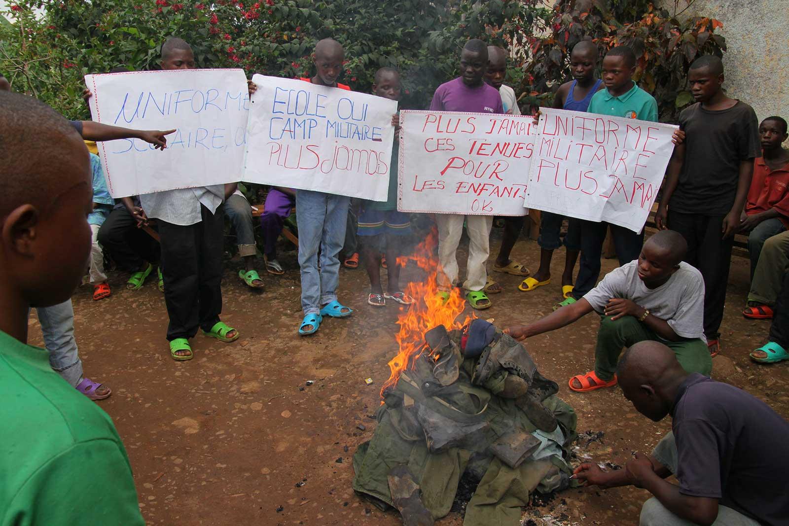 Former child soldiers burning their uniforms