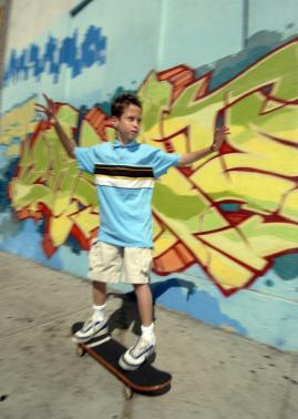 Nick, a homeless child in LA, on his skateboard. 