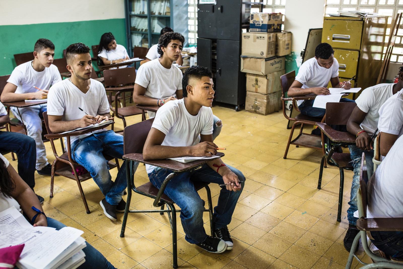 Boys sitting in classroom.