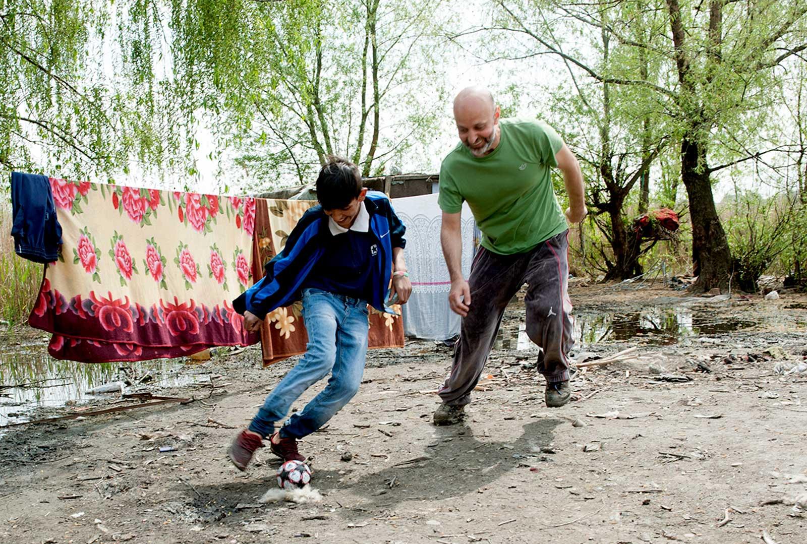 Valeriu and boy playing football