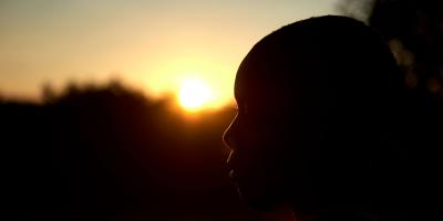 A profile of a girl, against the sunset