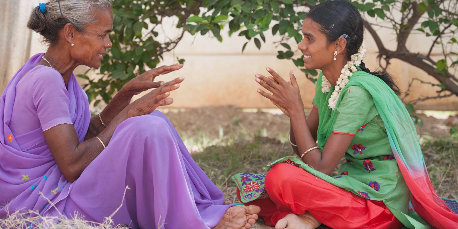 Alugumani and her mother use sign language