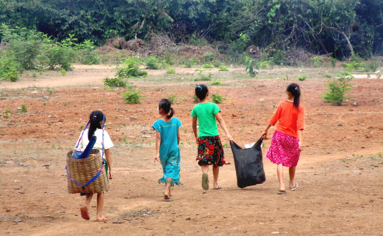Children with colorful clothes, walking away with trash