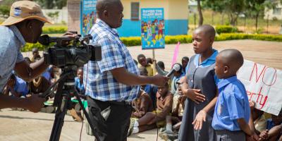 Children in Zimbabwe interviewed by TV  team. 
