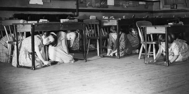 Children in classroom, hiding under tables