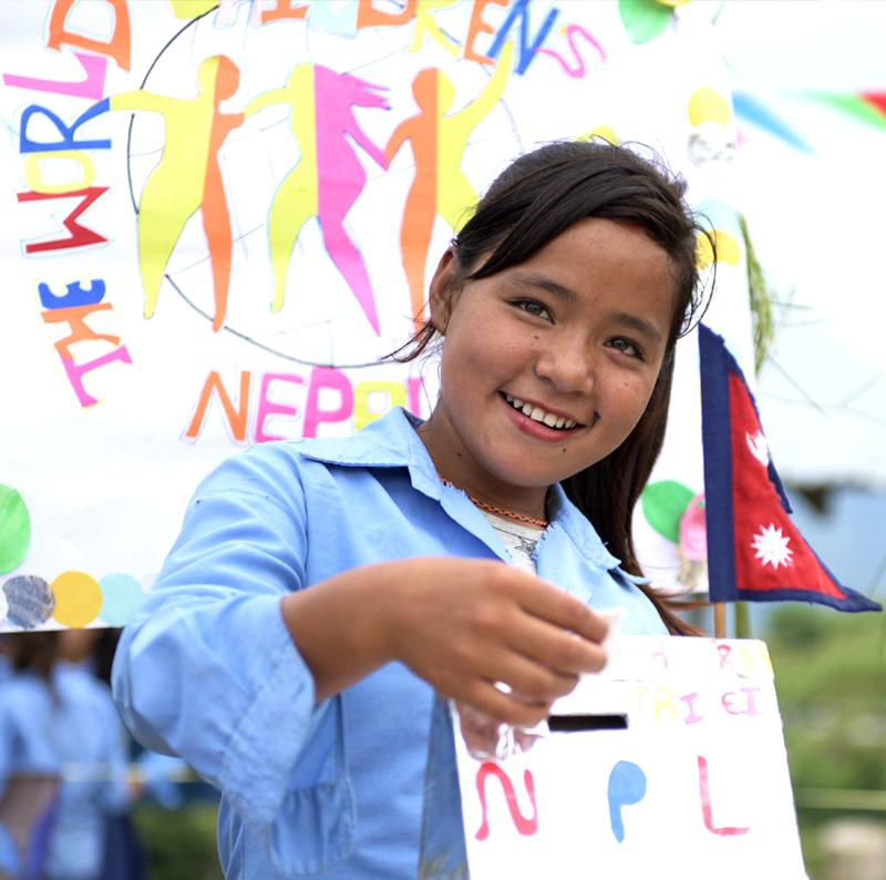 Nepali girls painting a sign