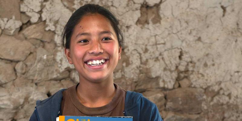 Girl from Nepal holding magazine