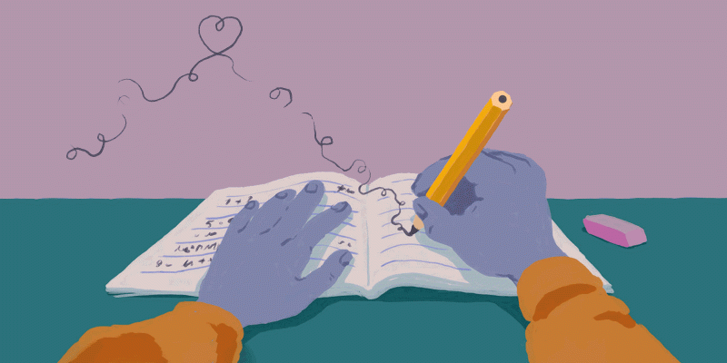 A child writes in a notebook. 