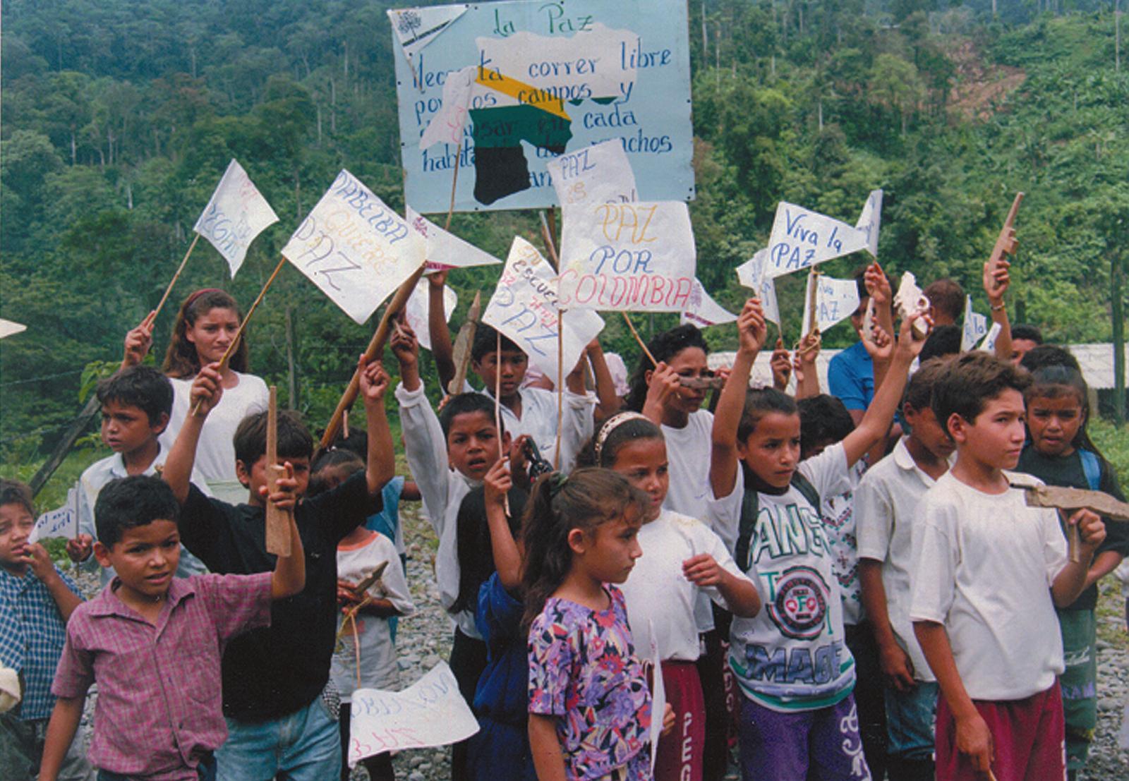 Children demonstrating for peace with home made signs.