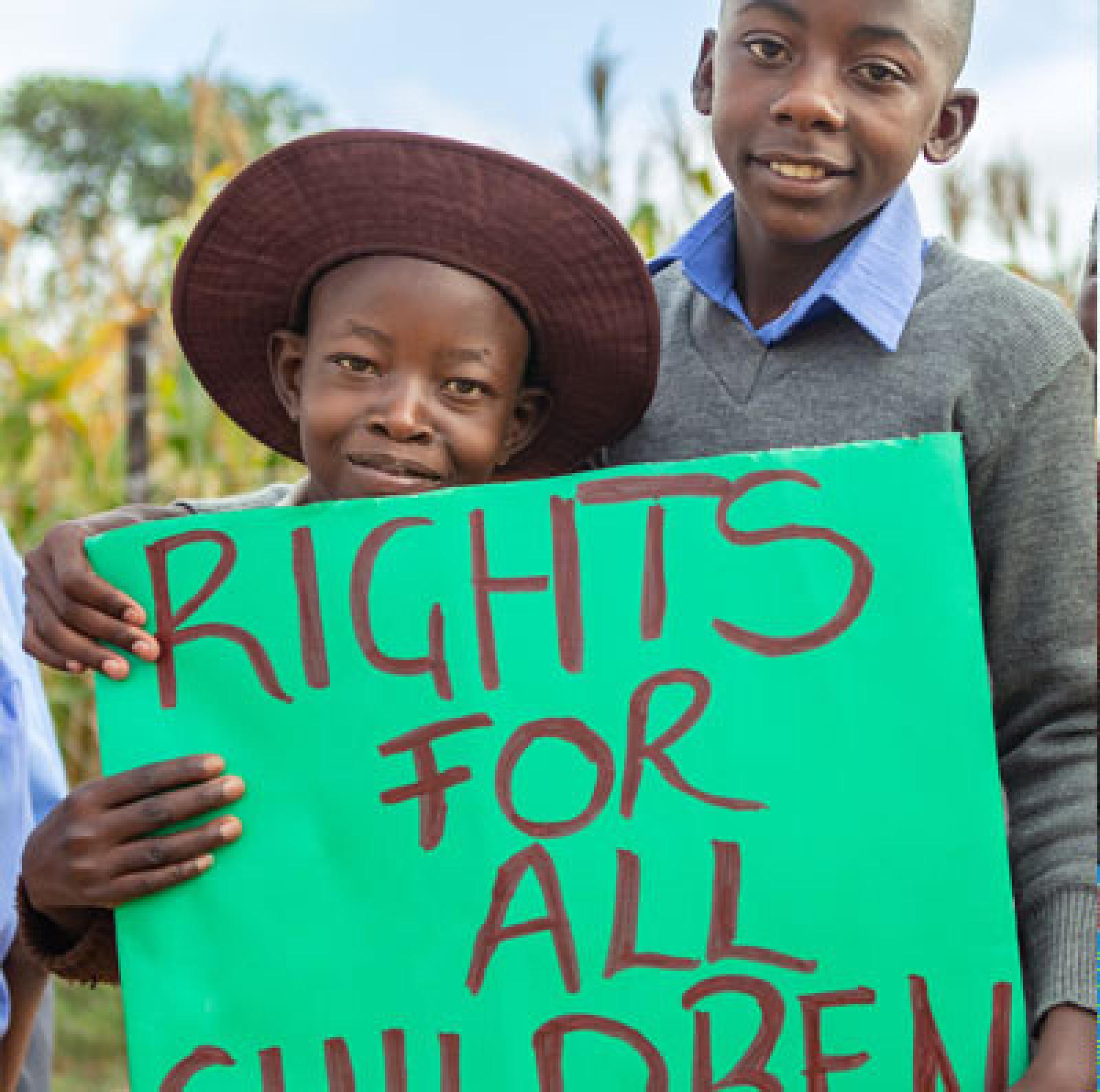 Girl and boy with sign: Rights for children