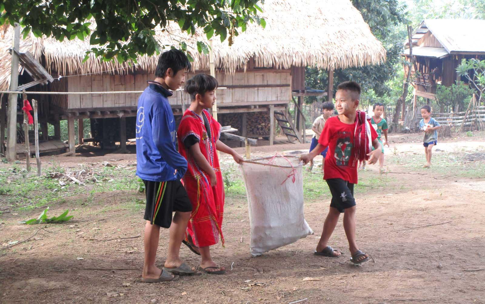 Three boys with rubbish bag
