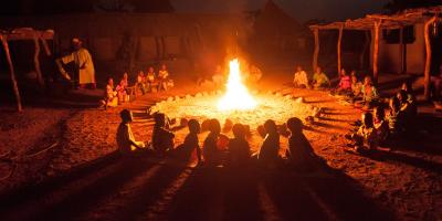 Children sitting around a fire