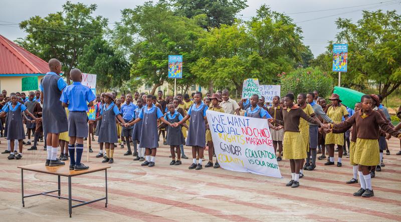 Children demonstrationg for child rights in school yard