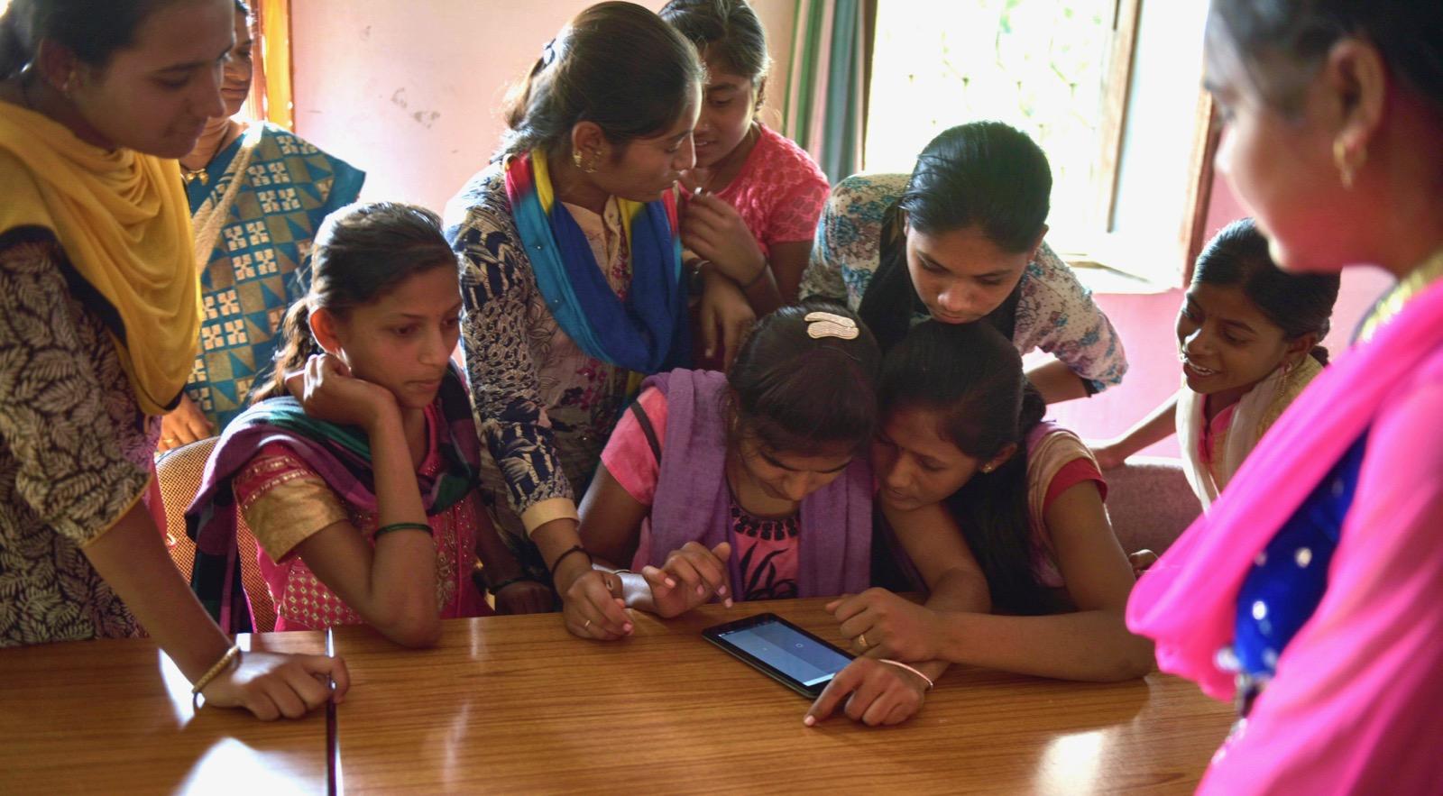 a group of girls watching a tablet