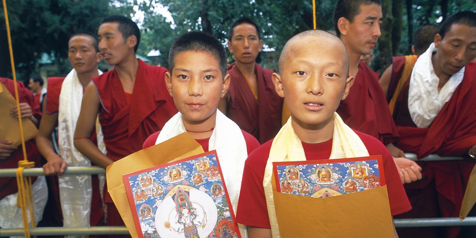 Two Tibetan boys and several Monks