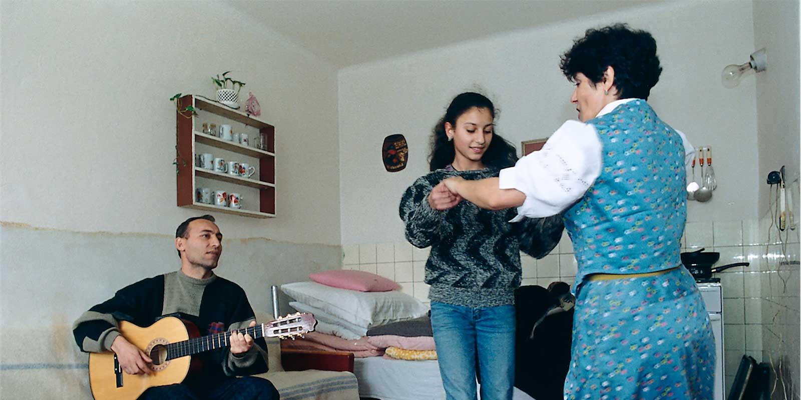 Svetlana dancing with her mother while her father playing guitar