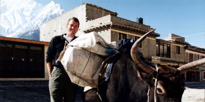 John Wood with fully loaded yak in Nepal mountains