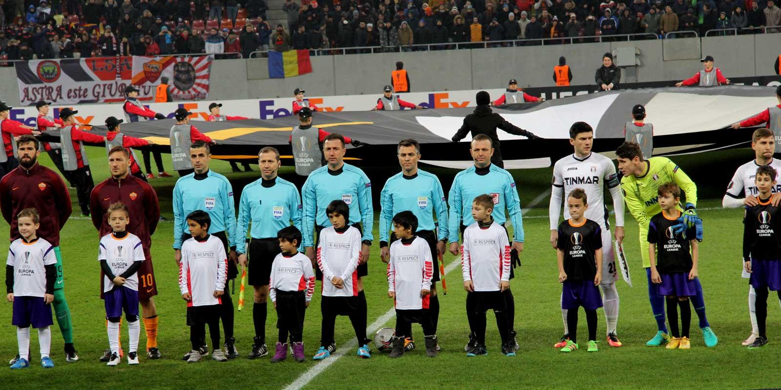 Children and players in Romanian football stadium
