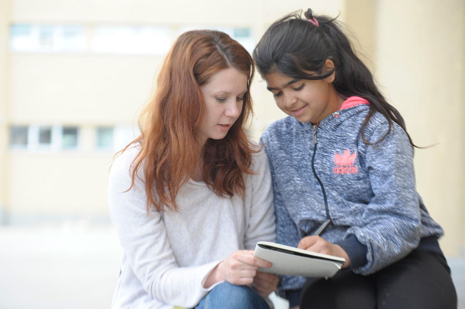 Zana and her tutor work together.