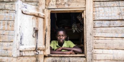 A portrait of a boy through a window.