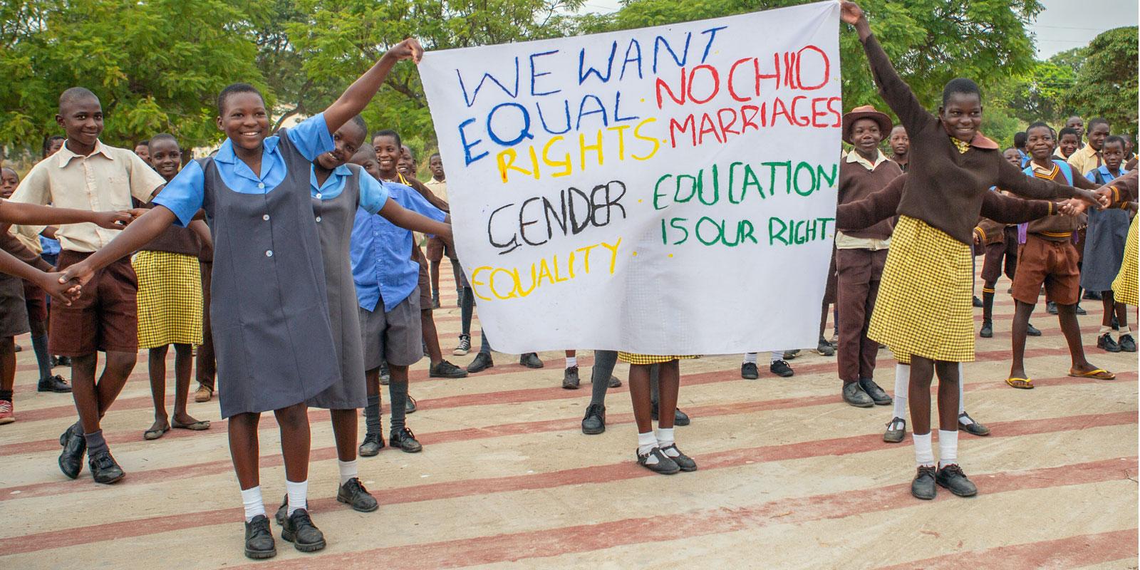Children holding banner with messages about the rights of the child